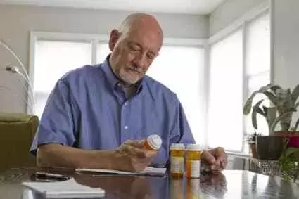 Older man with prescription medications.