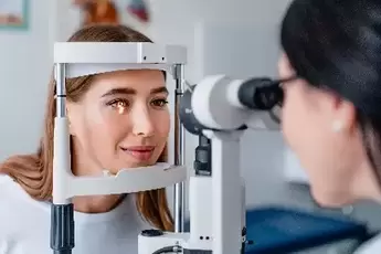 female doctor giving a young female an eye exam