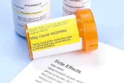 Prescription bottle with warning label and drug side effects print out