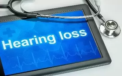 Hearing loss written on chalkboard surrounded by medical equipment
