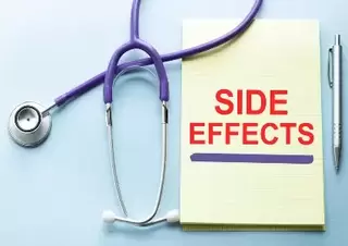 Side effects written in red on a yellow notepad surrounded my medical equipment.