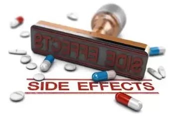 Rubber stamp with the word side effects over white background with pills and tablets. Concept of risk assesment of drugs or medical treatment. 3D illustration.