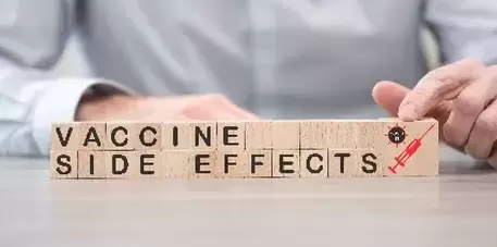 Concept of Covid-19 vaccine side effects on wooden cubes